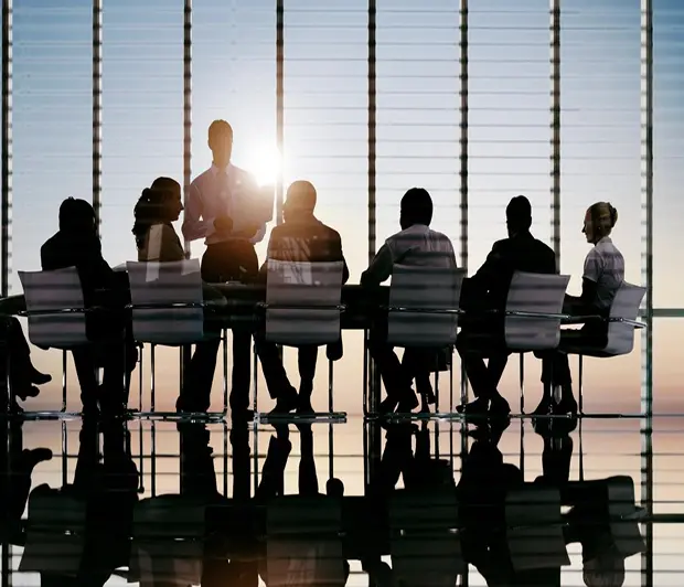 GettyImages-1371154238 (1)-9 A group of people sitting at a table in front of a window.